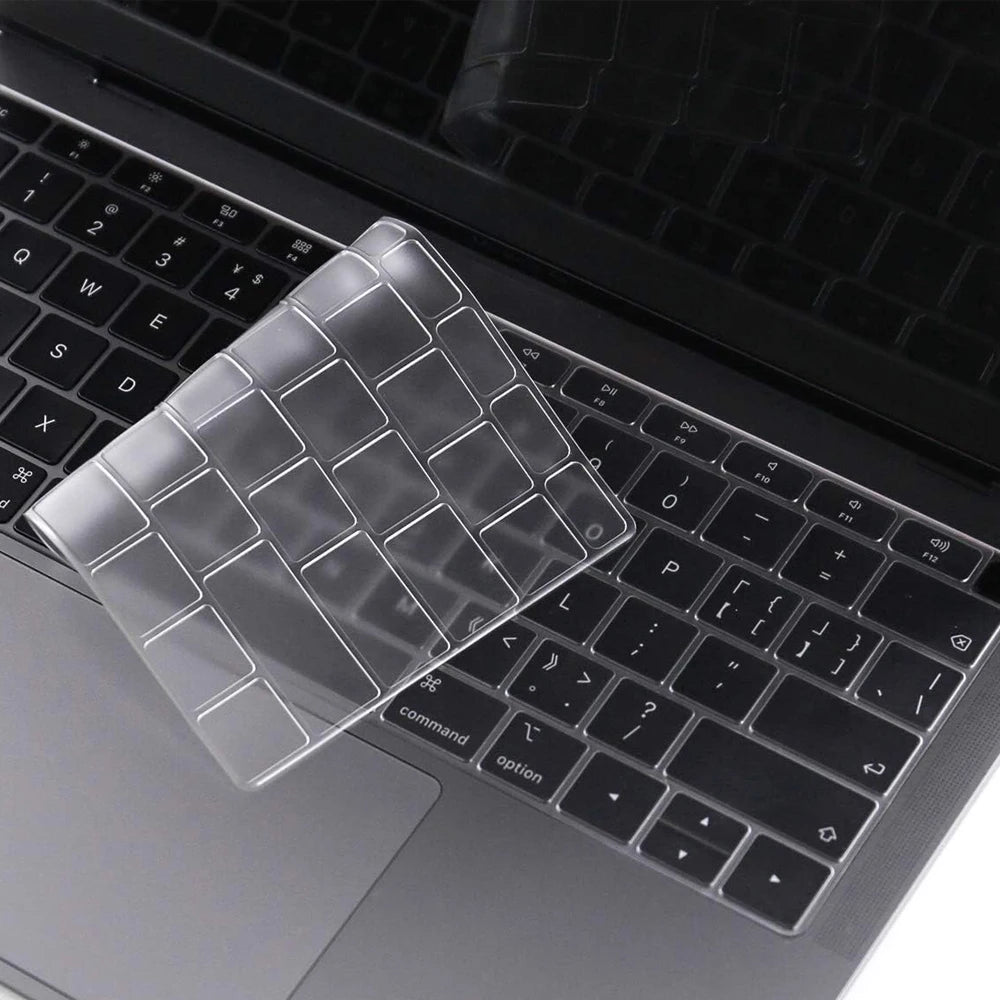 A clear silicone keyboard cover is placed on a black MacBook keyboard.