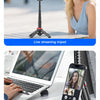 A woman smiling while using a magnetic selfie stick tripod for live streaming and a phone stand.