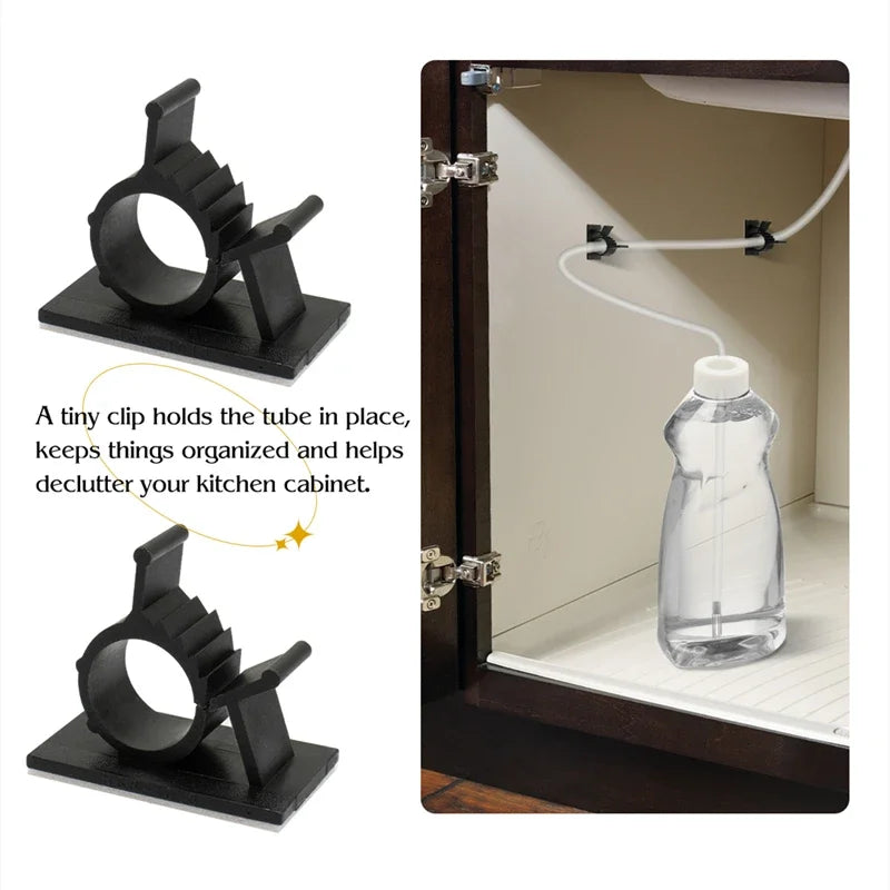 A black clip holds a tube in place inside a cabinet, used to organize kitchen items.
