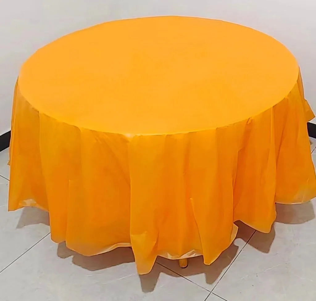 A vibrant orange disposable round tablecloth is displayed on a white surface.