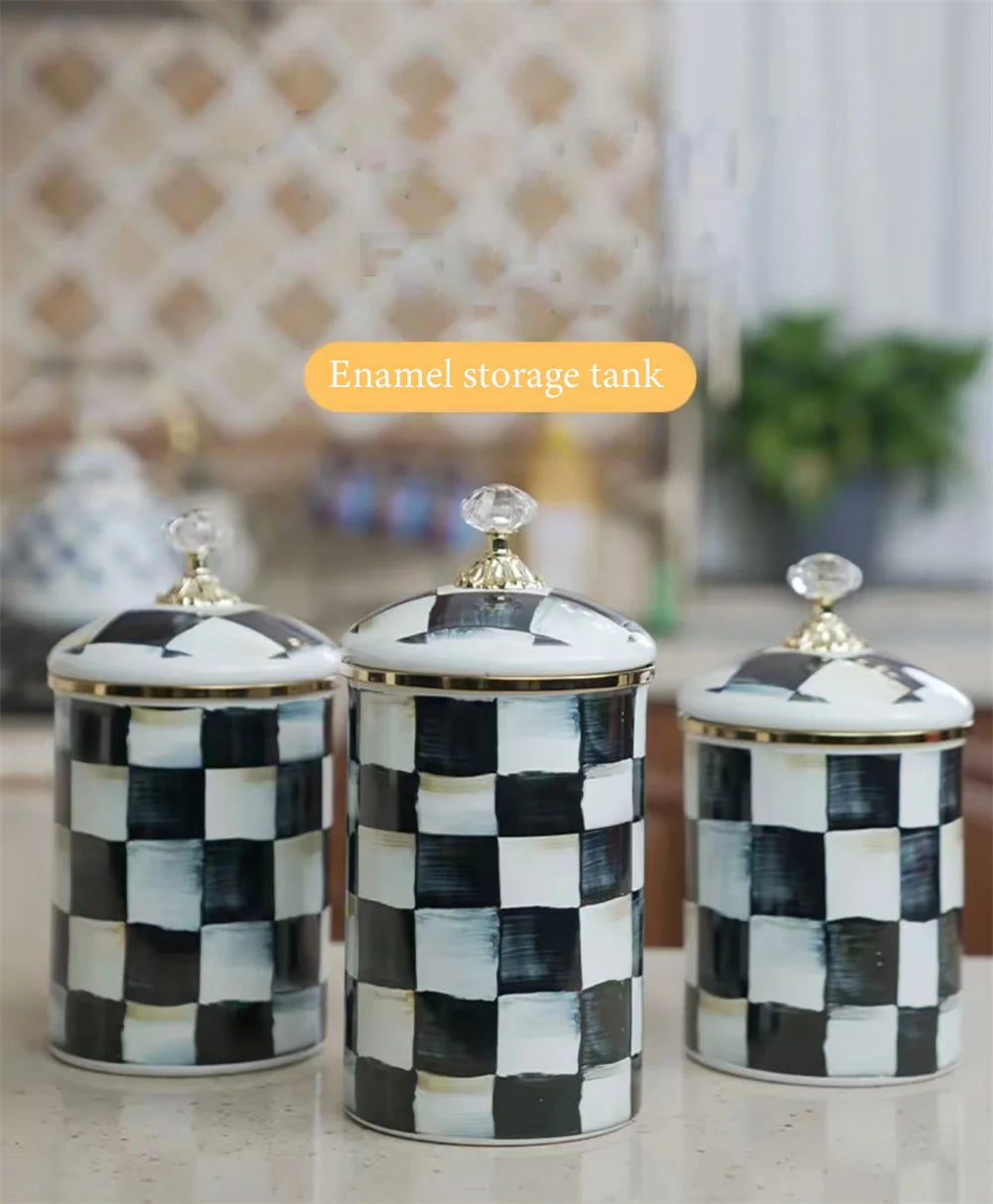 Three enamel storage tanks with a black and white checkerboard pattern on a light background.