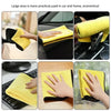 A set of yellow microfiber cleaning towels being used to wipe down car interiors, household surfaces, and electronic devices.