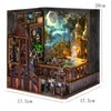 A wooden DIY book nook kit featuring a detailed miniature house scene with architecture and landscape elements.