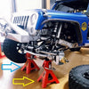 A blue RC crawler is supported by a pair of red metal jack stands on a wooden floor.