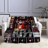 A black and white printed flannel throw blanket featuring various images of the Kiss band members.