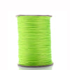 A spool of bright lime green waxed cotton cord for jewelry making