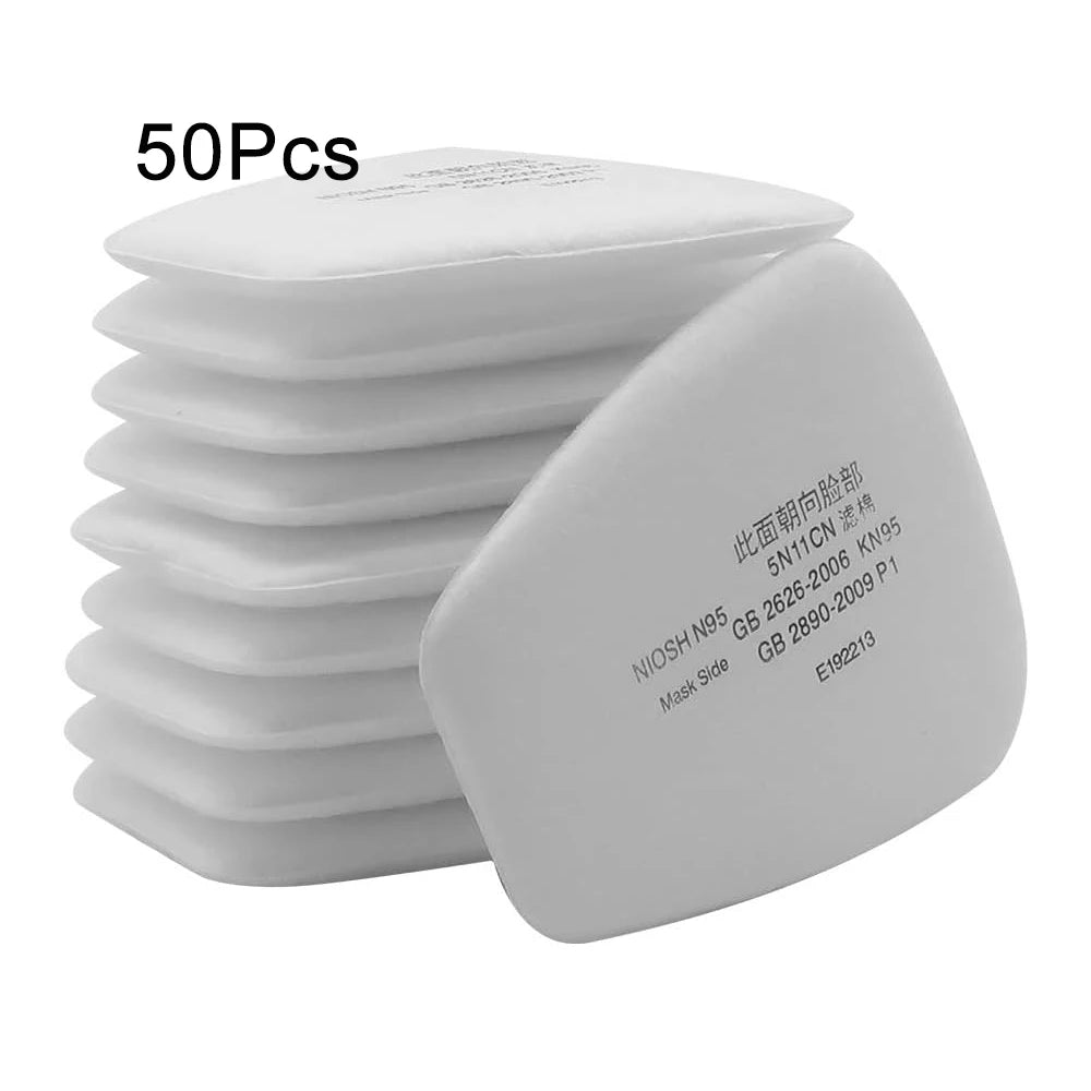A stack of white replacement dust filter pads for respirators, showing the individual pad labeled with product codes.