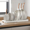 A silver organizer rack holds several round pots and pans with wooden handles.