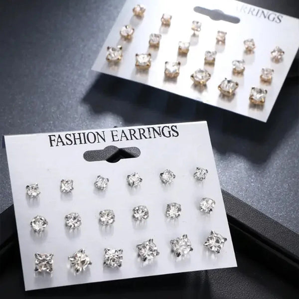 A display of classic rhinestone stud earrings in various sizes and styles on white cards.