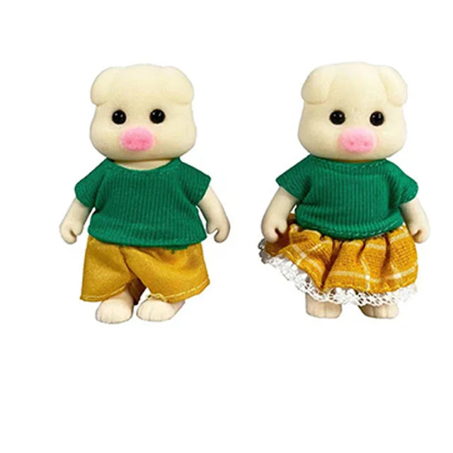 A pair of small, cream-colored animal dolls dressed in green shirts and yellow bottoms.