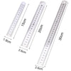 A stainless steel precision ruler showing measurements in centimeters and inches.