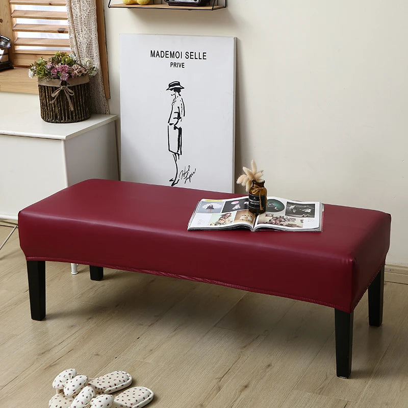 A deep red waterproof PU stretch bench cover with an elastic edge resting on a light wood floor.