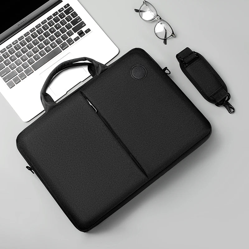 A black men's business commuter laptop briefcase with a shoulder strap and a black sleeve is shown next to a silver pair of g