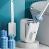 A white wall-mounted disposable toilet brush set with a blue replaceable head is shown next to a toilet.