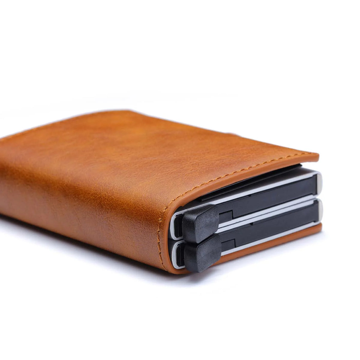 A brown leather wallet with a black sleeve showing two credit cards inside.