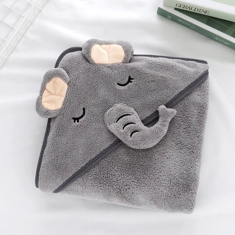 A gray, fluffy hooded baby bath towel with a cute elephant face design.