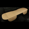A tan breathable PU leather car seat cover is shown lying on a dark car seat interior.