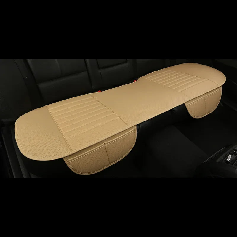 A tan breathable PU leather car seat cover is shown lying on a dark car seat interior.
