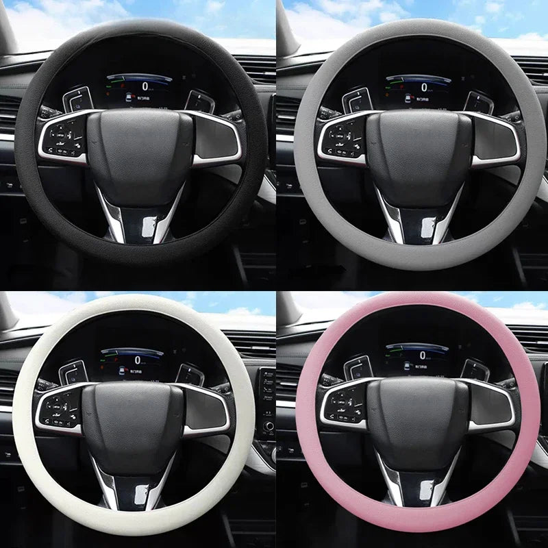 Four views of a steering wheel covered in soft silicone material in black, white, and pink colors.
