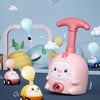 A pink balloon-powered racing car toy is shown with yellow and white cars, clouds, and balloons in a light blue background.