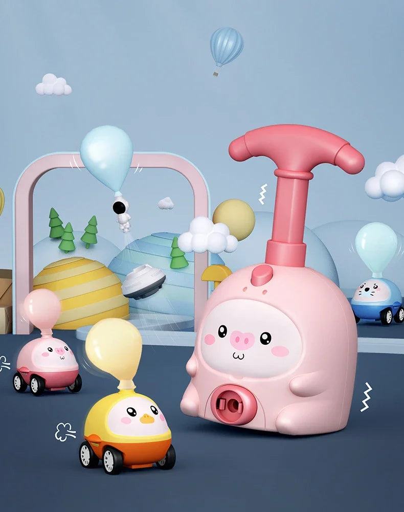 A pink balloon-powered racing car toy is shown with yellow and white cars, clouds, and balloons in a light blue background.