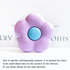 A light purple, flower-shaped silicone phone grip stand with small black dots on the surface.