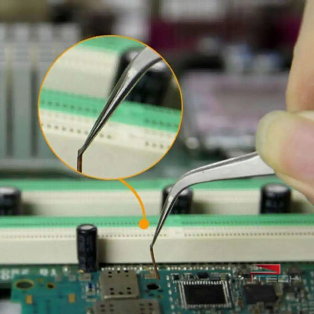 A close-up view of precision stainless steel tweezers being used on an electronic circuit board.