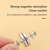 A hand is holding a silver magnetic curtain clip, demonstrating its close suction and easy installation.