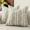A close-up of a vintage striped floral throw pillow cover with sage green and cream tones.