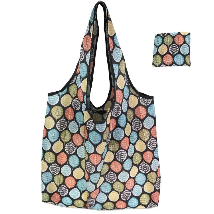A foldable floral shopping tote bag featuring a patterned fabric and an attached carry pouch.