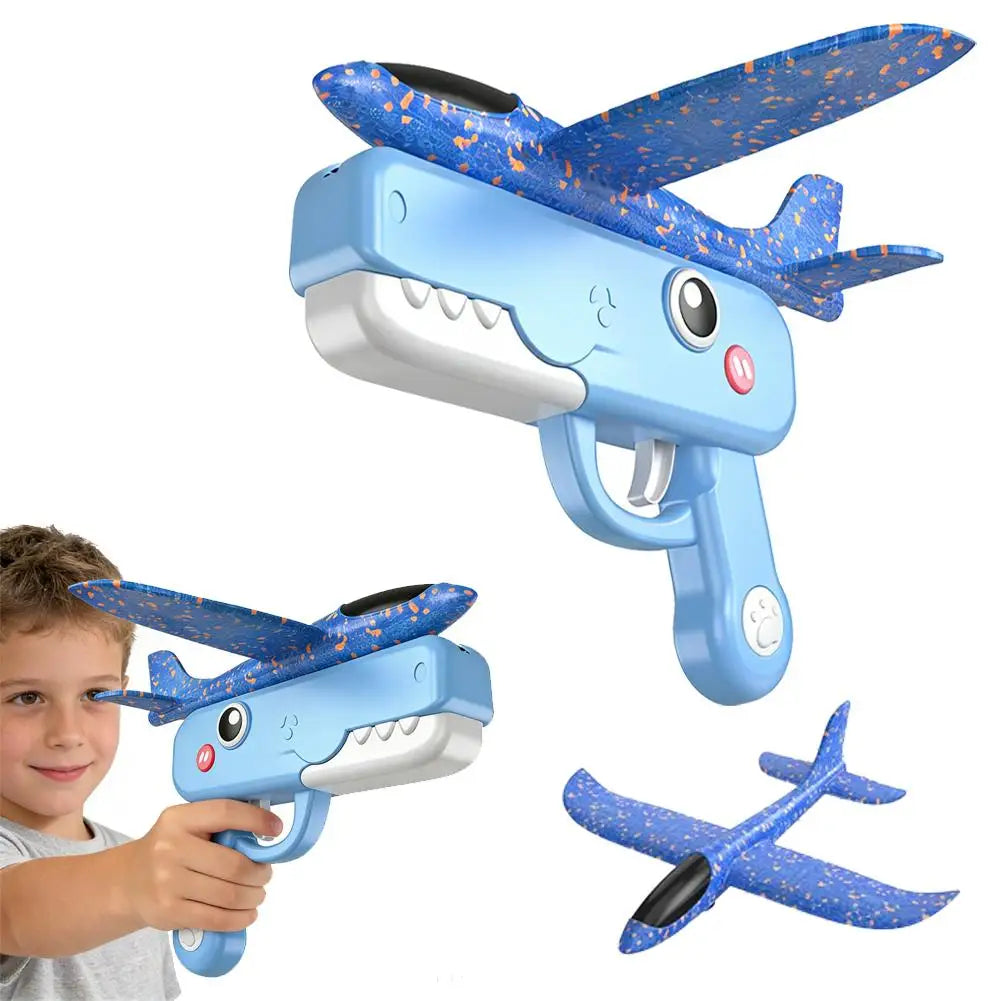 A blue foam catapult airplane toy with orange patterned wings is shown being held by a child.