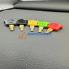 A set of five colored replacement ignition keys for Caterpillar excavators, including black, gray, yellow, green, and red.