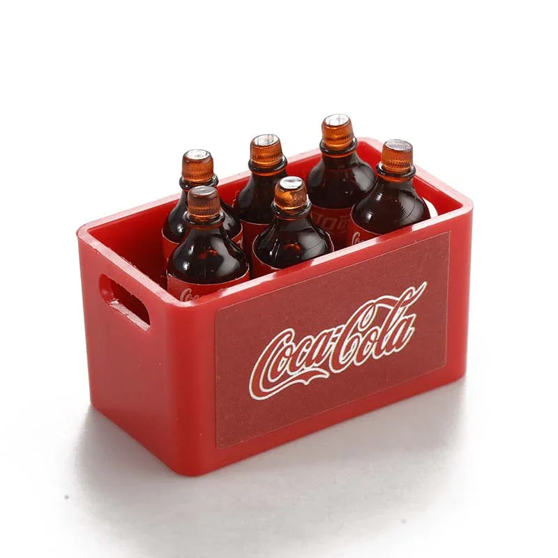A red plastic box containing three glass bottles with corks, used as decorative accessories for an RC car.