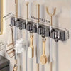 Wall-mounted metal holder for mops and brooms with detachable hooks, showing various cleaning tools.