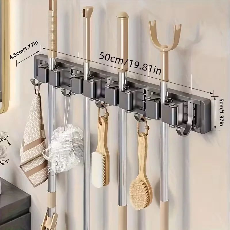 Wall-mounted metal holder for mops and brooms with detachable hooks, showing various cleaning tools.