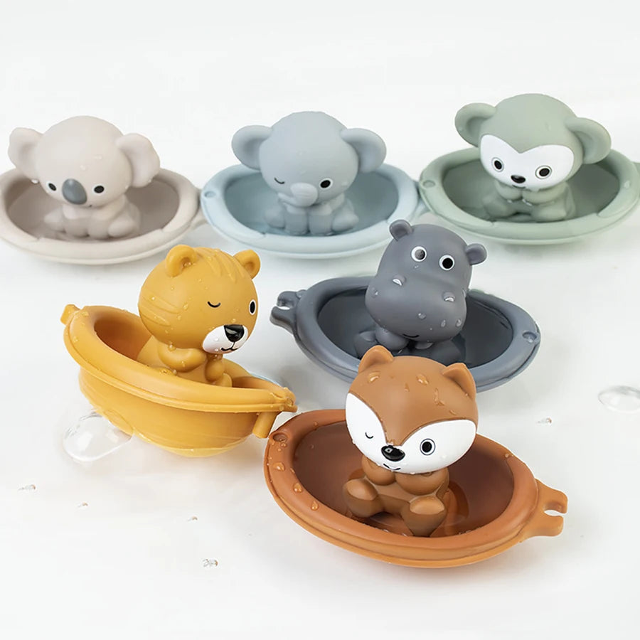A collection of silicone animal finger puppets in various shades of gray, beige, and green, designed as bath toys for toddler
