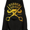 Black waterproof hair cutting cape featuring a yellow barber shop design with a mustache and crossed scissors.
