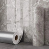 Roll of gray marble peel-and-stick waterproof wall panels displayed next to a cylindrical panel.