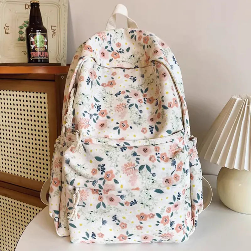A floral patterned backpack set featuring a main bag, a smaller bag, and a pencil case.