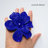 A hand holds a vibrant royal blue crystal rhinestone flower sew-on patch, measuring 11cm or 4.33 inches.