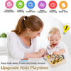 A young girl is playing with a wooden busy board sensory toy while a baby watches nearby.