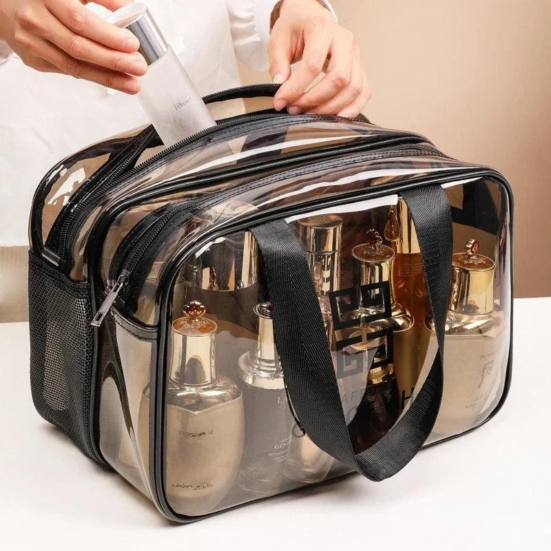 A transparent PVC travel toiletry bag with wet-dry separation is being held by a person.