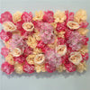 A dense wall panel of pink and peach silk rose flowers for weddings and events.