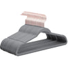 A set of gray velvet hangers with pink 360 degree swivel hooks for clothing.