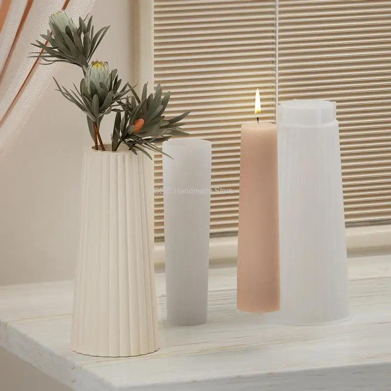 A white silicone mold is shown next to three pillar candles in varying heights on a light wooden surface.