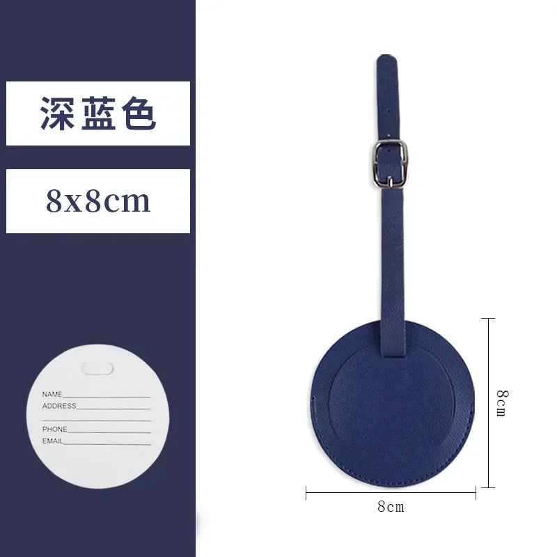 A dark blue PU leather luggage tag with a round shape and a metal clip.