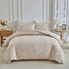 A beige Nordic leaf print duvet cover set displayed on a bed with white molding and light-colored bedding.
