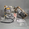 A box and components for a premium metal spinning top battle set featuring a black top and accessories.