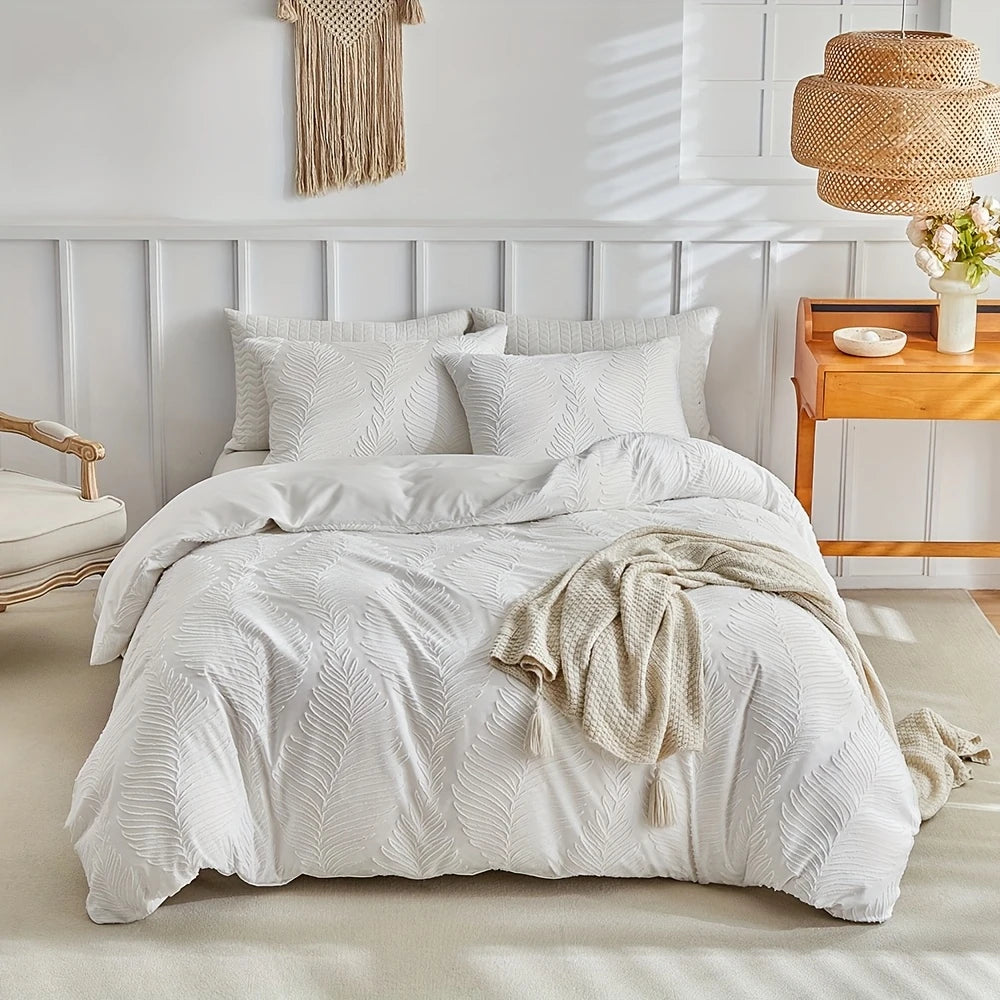A white microfiber duvet cover set with an embossed leaf pattern displayed on a bed.