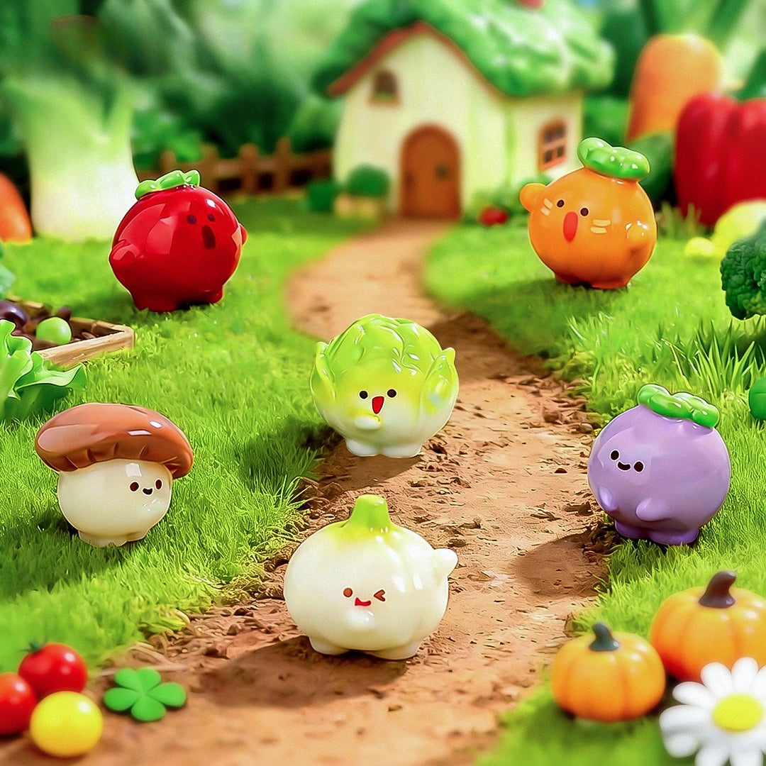 Hand-painted resin vegetable figurines like tomatoes, squash, and peas arranged on a grassy path in a garden setting.